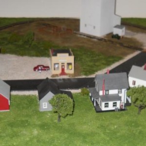Here you can see a few of the details I've added.  There are now trees behind some of the houses; there's a car and a man by the store; and a truck an