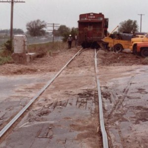 10th Street crossing had a standard flasher on it. This shows sand at the point of impact. BN local 3111 is the Westbound six day a week local from Tu