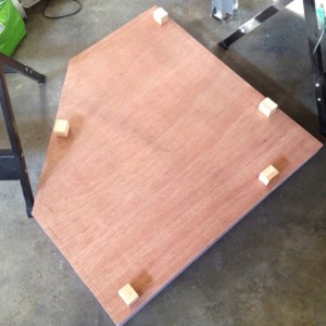 benchwork 5 : So, the foam and wood underlayment are inverted and on the garage floor while the yellow glue sets up. The five blocks are used to align