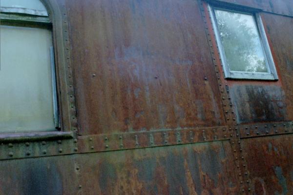 Ex-Rock Island Baggage/Passenger Coach. Faded Rock Island Logo. This Coach is on display at The ES&NA RR Yard.