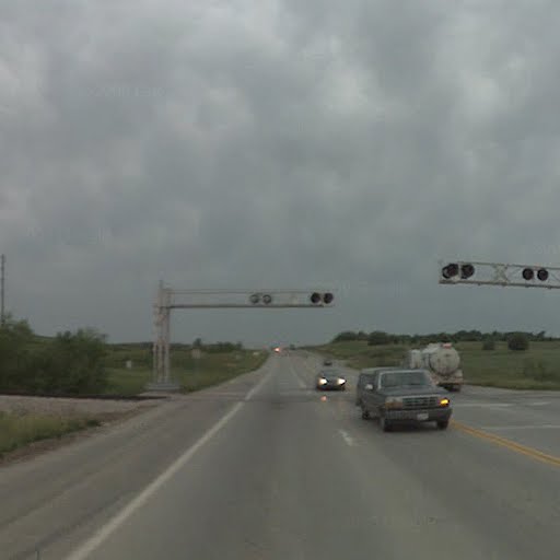 MO HWY 150 crossing looking west. This crossing now has regular traffic lights instead of the normal flashing red lights associated with RR grade cros