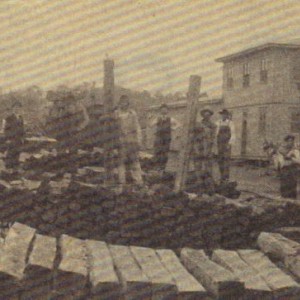 This picture is a clipping from the Douglas County Herald from 1991. It features the Ava, MO depot with piles of crossties. Photo dates to about 1915.