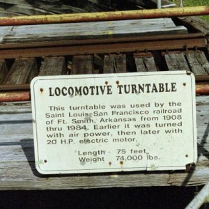 A sign on the Locomotive Turntable read: Locomotive Turntable This turntable was used by The Saint Louis - San Francisco Railroad of Ft. Smith, Arkans