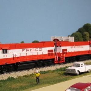 GP15-1s 118 and 100 pull a light extra north through Lenexa in 1979.  Looks like a local railfan and his son are enjoying the sights.